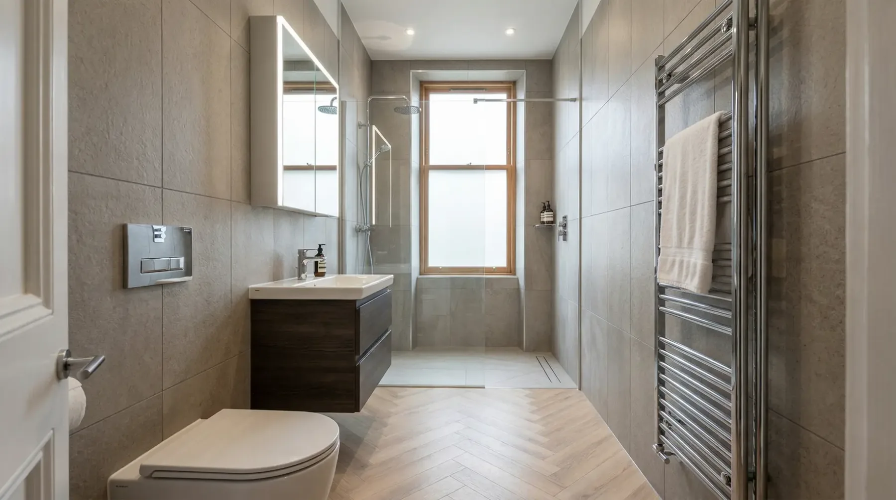 Narrow bathroom with a tall window, wall-hung vanity and glass shower screen